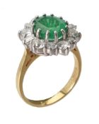 An emerald and diamond cluster ring