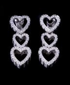 A pair of diamond triple heart ear pendants