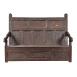 A carved oak settle