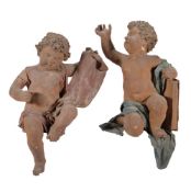 A pair of Continental painted papier mâché and composition models of putti