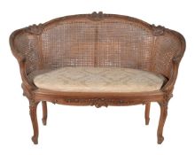 A French walnut settee in Louis XVI style