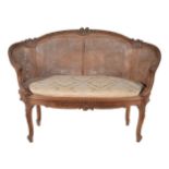 A French walnut settee in Louis XVI style