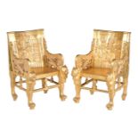 A pair of carved giltwood armchairs