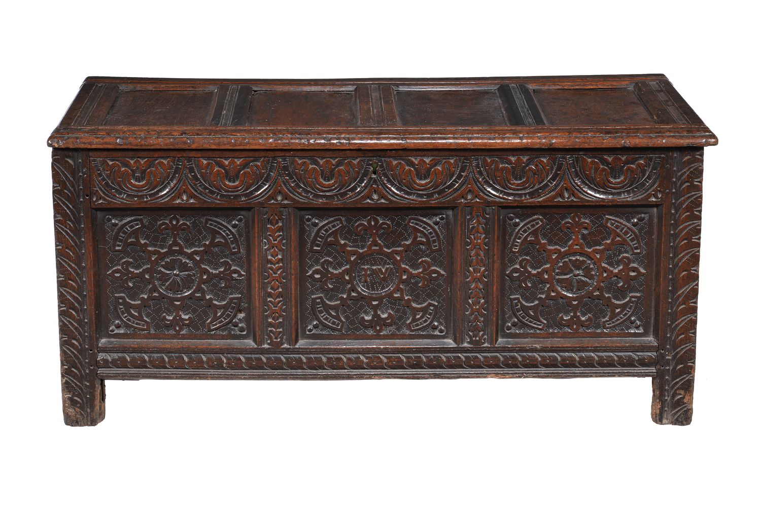 A carved and panelled oak coffer