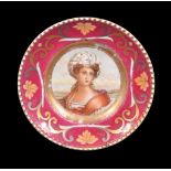 A Russian porcelain (Kuznetzov Factory) portrait plate painted with a woman wearing elaborate headre