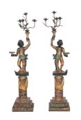A pair of carved, painted, ebonised, and parcel gilt wood blackamoor torcheres