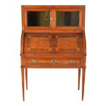 ϒ A Continental mahogany, amboyna inlaid, and rosewood banded cylinder desk