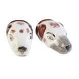 Two Staffordshire pottery hounds head stirrup cups painted with brown patches