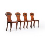 A set of four George III mahogany hall chairs