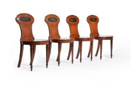 A set of four George III mahogany hall chairs