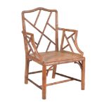 A carved beech simulated bamboo armchair