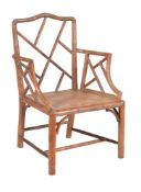 A carved beech simulated bamboo armchair