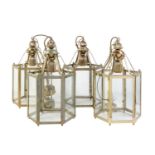 A set of four gilt metal and glazed hexagonal hall lanterns