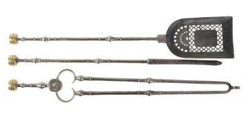 A set of late George III or Regency steel and brass mounted fire irons