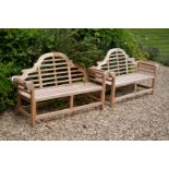 A pair of teak garden benches