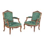 A pair of carved walnut armchairs in Louis XVI style