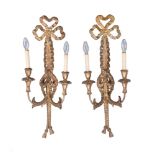 A pair of carved and giltwood twin light wall appliques