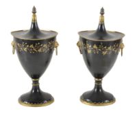 A pair of black and gold painted and lacquered metal chestnut urns and covers in the style of Regenc