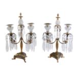 A pair of patinated and parcel gilt bronze and cut glass mounted twin light lustre candelabra in Reg