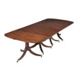 A mahogany four pillar dining table