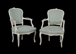 A pair of white painted and turquoise upholstered open armchairs in Louis XVI style