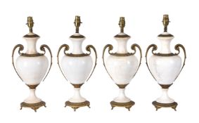 A set of four Continental gilt metal mounted glazed ceramic table lamps
