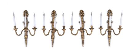 A set of four painted composition three light wall appliques in Louis XVI taste