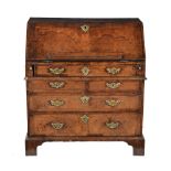 A George I walnut and feather banded bureau