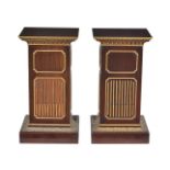 A pair of stained wood and parcel gilt pedestals