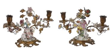 A pair of Continental porcelain mounted gilt-metal twin-light figural candelabra in Louis XV style