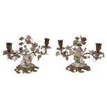 A pair of Continental porcelain mounted gilt-metal twin-light figural candelabra in Louis XV style