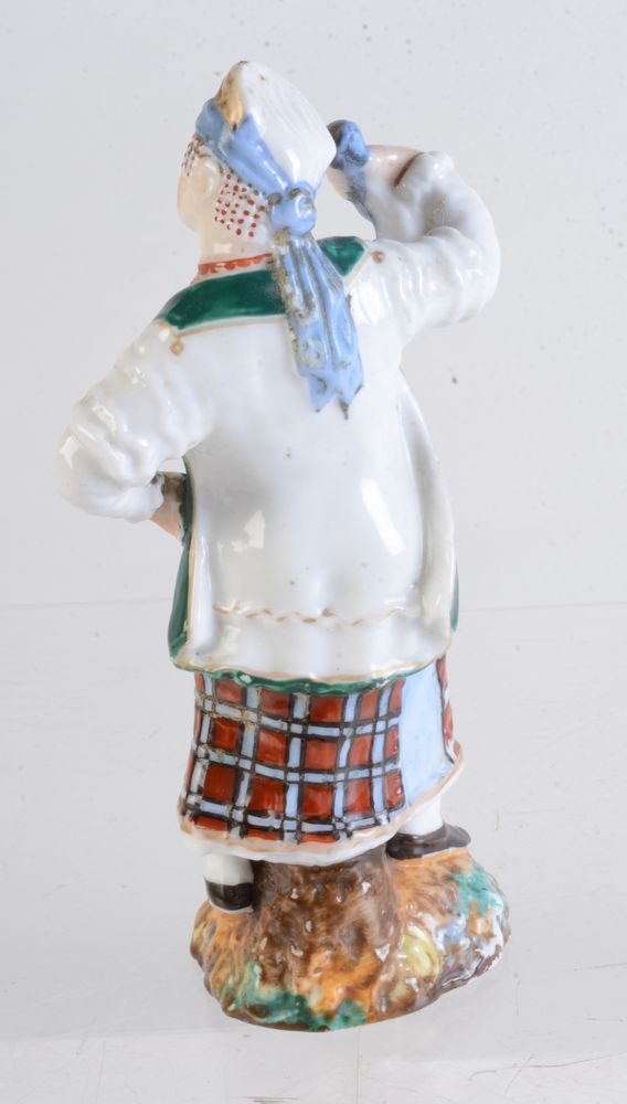 A Russian porcelain figure of a peasant woman - Image 2 of 3