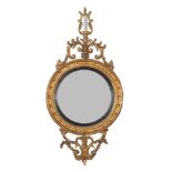 A carved giltwood convex wall mirror in Regency style