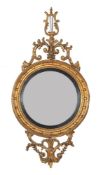 A carved giltwood convex wall mirror in Regency style