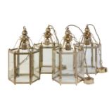 A set of four gilt metal and glazed hexagonal hall lanterns