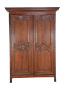 A Louis XV carved walnut two door press cupboard