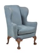 A walnut and upholstered wing back armchair in George II style