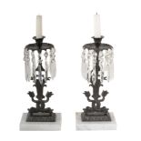 A pair of patinated metal, cut glass and marble mounted lustre candlesticks in Regency taste