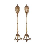 A pair of Italian carved giltwood and glazed standard lanterns in 18th century Venetian taste
