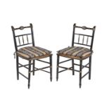A pair of Regency black painted side chairs