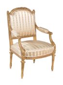 A carved giltwood and composition armchair in Louis XVI style