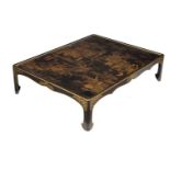An ebonised, black lacquer and gilt Chinoiserie decorated low table