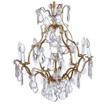 A gilt metal and cut glass hung eight light chandelier in Louis XV style