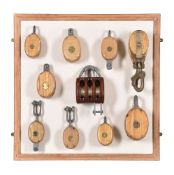 A collection of Abeking & Rasmussen sheaving blocks mounted on board