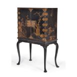 A black lacquer and gilt chinoiserie decorated cabinet on stand