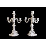 A pair of Meissen white porcelain and gilt four-branch candelabra