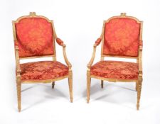 A pair of George III carved giltwood armchairs