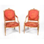 A pair of George III carved giltwood armchairs