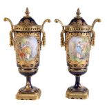 A pair of French porcelain Sèvres-style blue-ground and gilt and gilt-metal-mounted two-handled urns