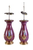 A pair of French painted and parcel gilt porcelain and giltwood table lamps